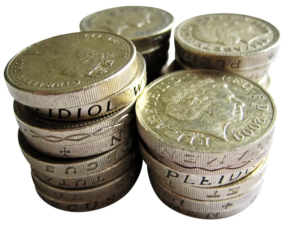 Stacks of British one-pound coins close up.